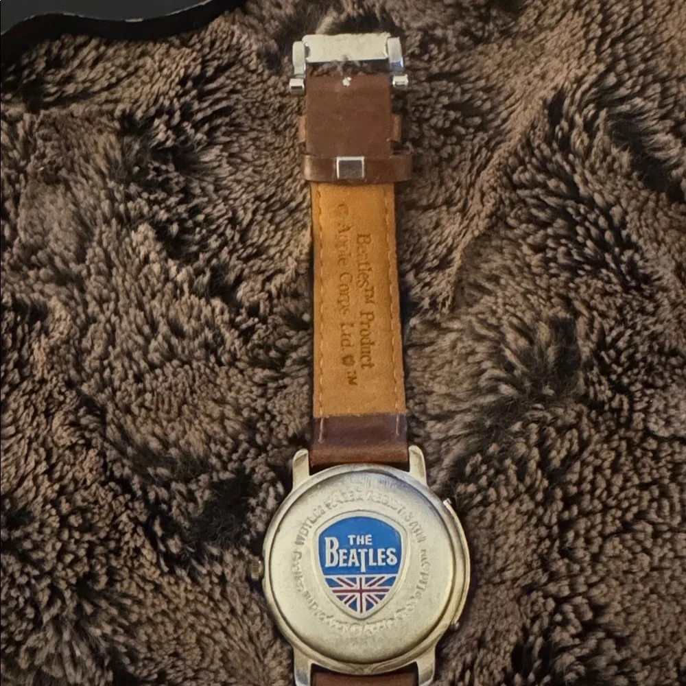 The Beatles Apple Corps Ltd. watch in its original wooden guitar-shaped case.